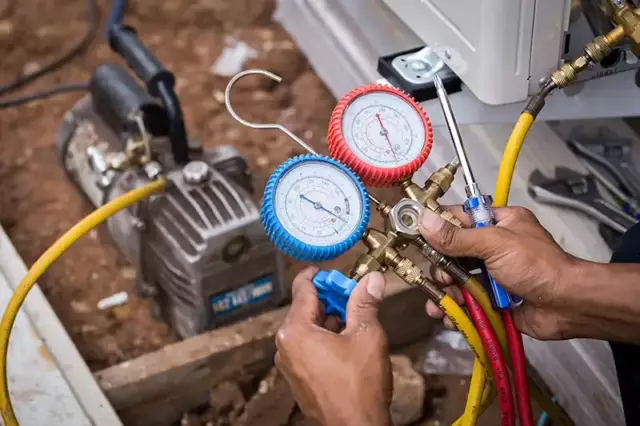 An HVAC technician prepares to diagnose an issue with a customer's AC unit.