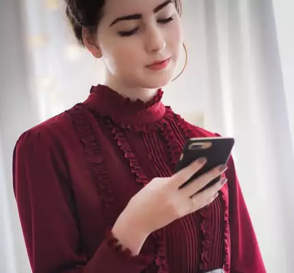 A lady using her cell phone to find an HVAC business